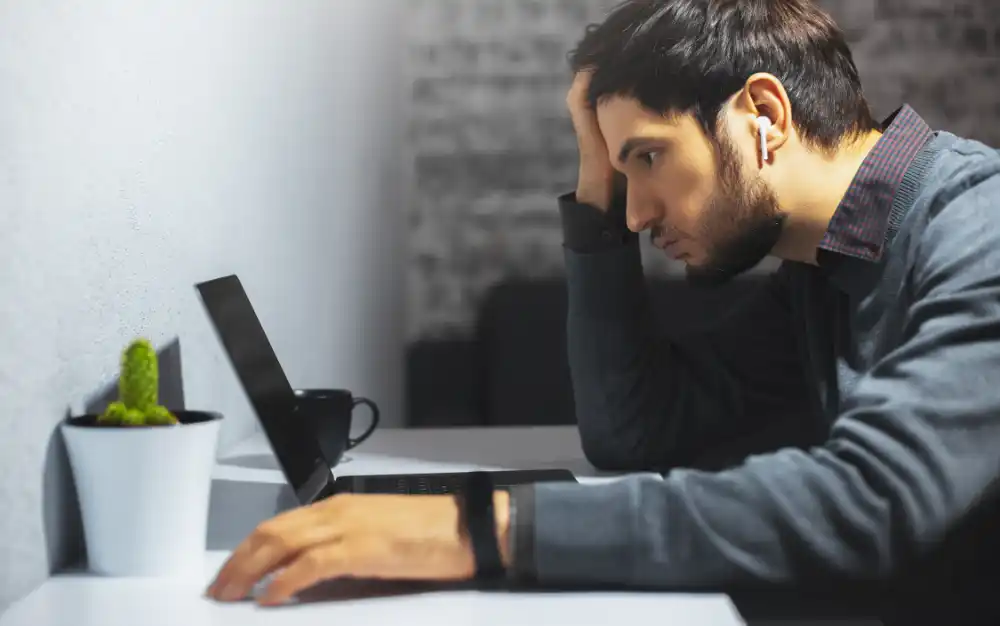 Young man with health anxiety on laptop