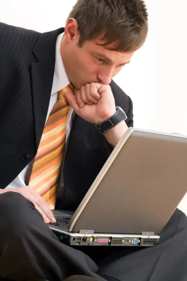 Anxious and worried man looking at his laptop