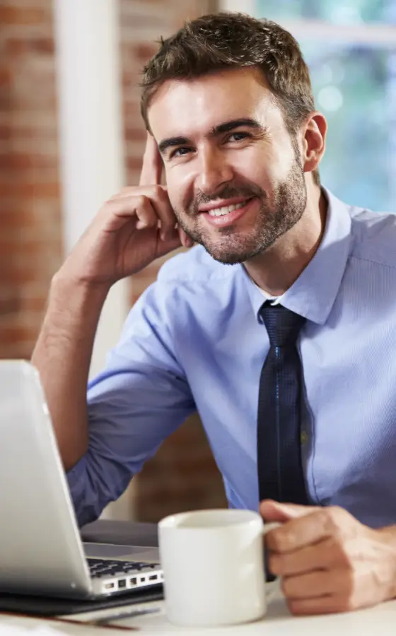 Man relaxed drinking tea during online mental health therapy session.