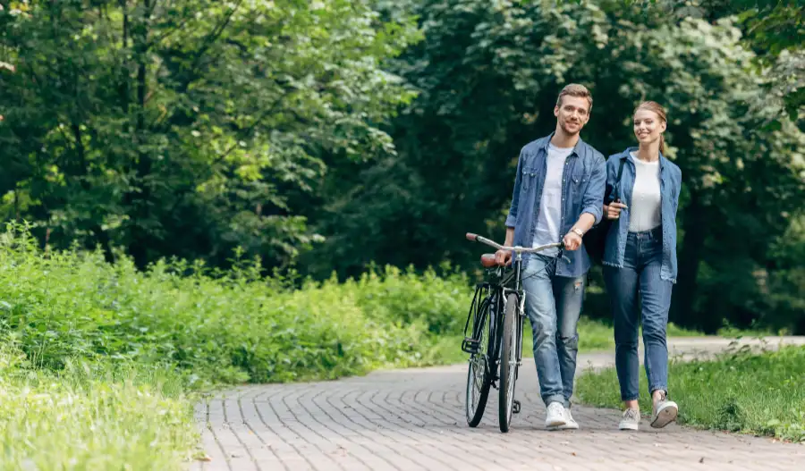 Young couple enjoying walking in woods after improving health habits
