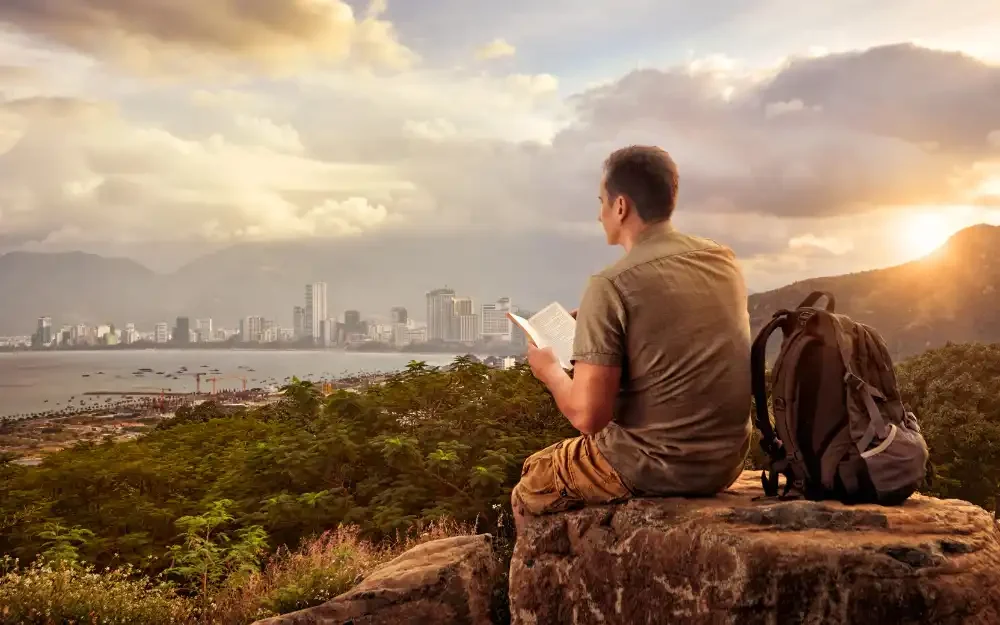 Young man with backpack deciding where to travel to.